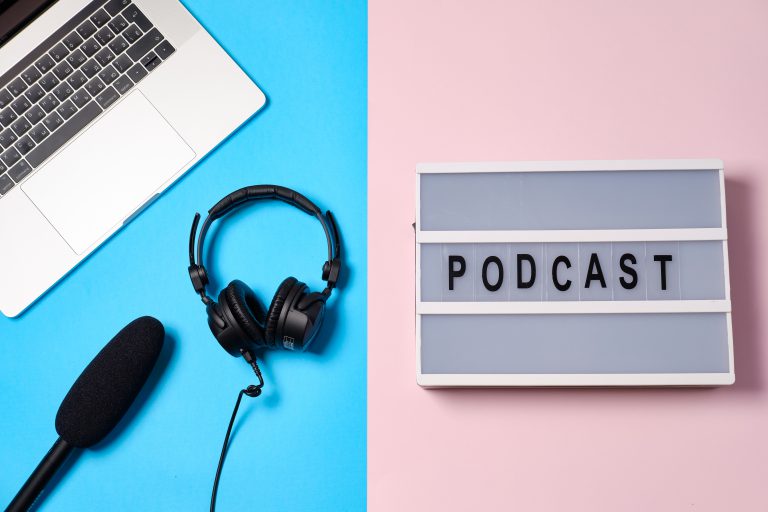 podcast w strategii content marketingowej mikrofon słuchawki i napis świetlny